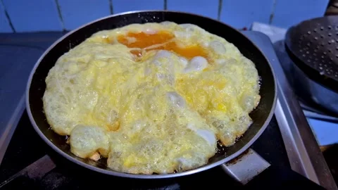 An omelet being cooked in a frying pan Stock Footage 337583330