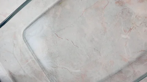 Omelet is being poured into a baking dish, top view. Slow motion homemade coo Stock Footage 119957468