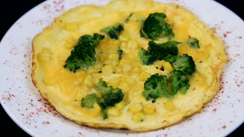 Omelet with broccoli and corn. Tasty breakfast. Scrambled eggs for breakfast Stock Footage 99863760