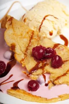 Omelet with cherry sauce and vanilla ice Stock Photos