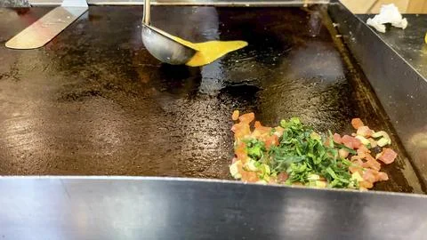 Omelet cooking on a griddle. Stock Photos