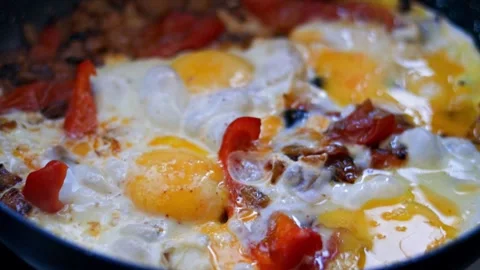Omelet in a frying pan. Dish with eggs, vegetables and sausage.  Stock Footage 253799850