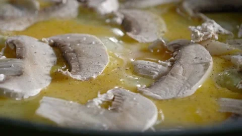 Omelet with mushrooms is baked on a pan Stock Footage 166327346