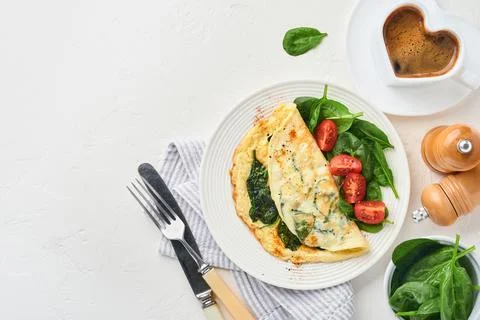 Omelet or omelette with spinach, cherry tomato and pepper seasoning on a whit Stock Photos