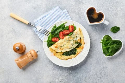 Omelet or omelette with spinach, cherry tomato and pepper seasoning on a whit Stock Photos