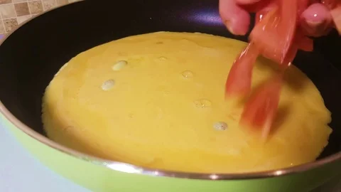 Omelet pour tomatoes Stock Footage 81067595