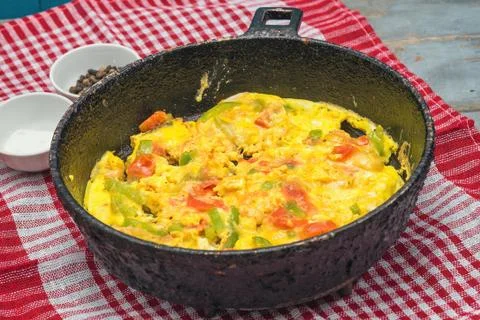 Omelet with vegetables in pot. Stock Photos
