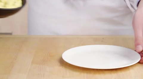 An omelette being transferred to a plate Stock Footage 24657293
