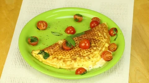 Omelette with cherry tomatoes Stock Footage 57523430