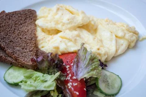 Omelette with grain bread and vegetables . Stock Photos