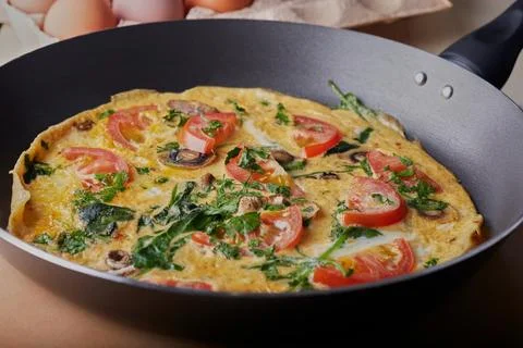 Omelette resting in pan. Stock Photos