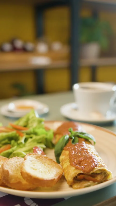 Omelette with Salad and Bread on a Breakfast Table Stock Footage 321938978