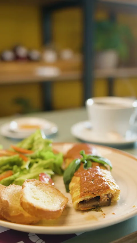 Omelette with Salad and Bread on a Breakfast Table Stock Footage 321939937