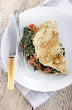 Omelette with spinach and tomatoes Stock Photos