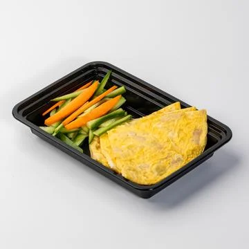 Omelette with vegetables in a plastic container Stock Photos