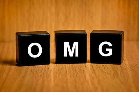 OMG or Oh My God word on black block Stock Photos