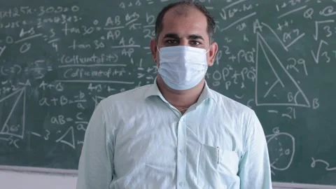 Omicron, Portrait Of Male Indian Math Teacher Wearing Mask Folding His Arms Stock Footage