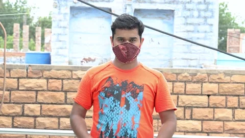 Omicron, Young  positive man remove his mask and doing namaste Stock Footage 136614945