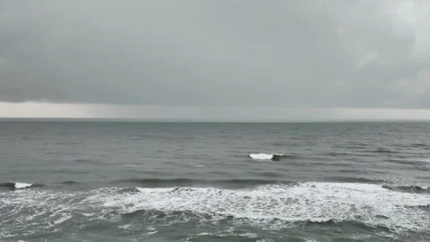 Ominous clouds build above the ocean before a storm, forming a moody marine Video stock 341481630
