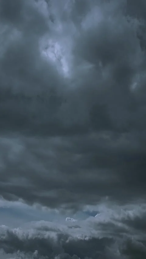 Ominous dark grey storm clouds filling the horizon before rain Stock Footage 341367719