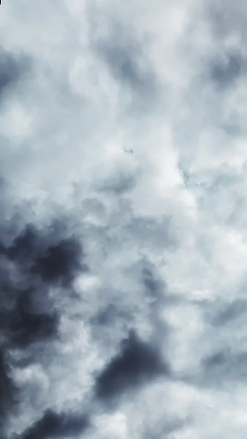Ominous grey cloud formations blow across sky overhead TIMELAPSE Video stock 315631382