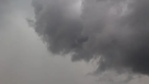 Ominous, heavy storm clouds looming over the low horizon Stock Footage 345654171