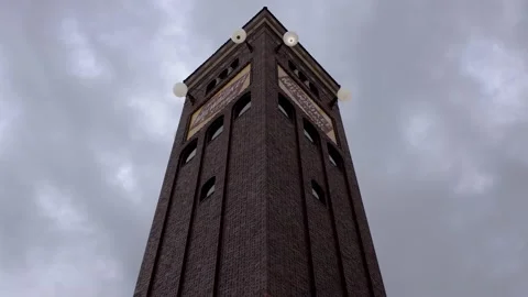 Ominous Tower Leering Above with Grey Clouds in Timelapse Stock Footage 201621982