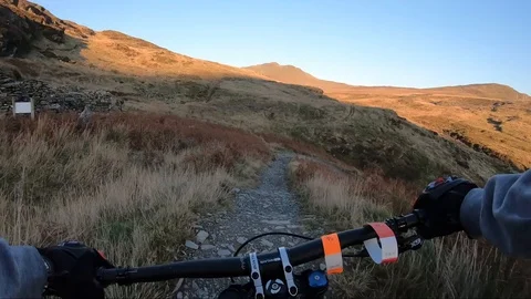 Onboard camera: Mountain biking downhill in stone road in Slate Mountain, Great Stock Footage 107725217