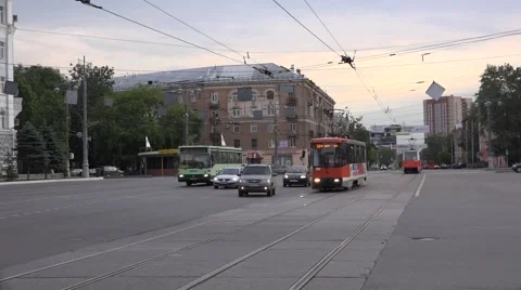 Oncoming trams cross a square in mixed traffic Stock Footage 64638757