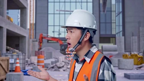 Ondering Engineer Saying Why Working Doubtfully at Construction Site Stock Footage 325855109