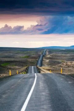Ondulated and empty road in the sub-artic icelandic landscape Stock Photos