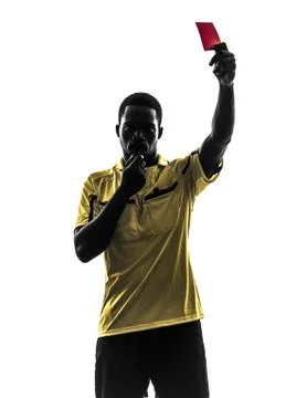 One african man referee standing showing red card  silhouette Stock Photos