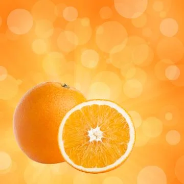 One and half oranges on abstract bokeh background Stock Photos