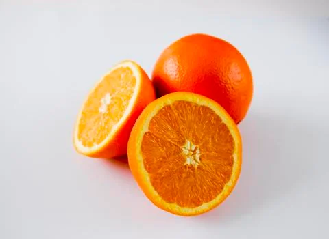 One and two half oranges whte background Stock Photos