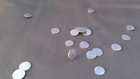 One and Two Rupees Indian Coins Dropping On Black Paper Floor in Slow Motion Stock Footage 267186878