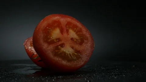 One appetizing ripe tomatoes on a mirror black background. Rotating table 動画素材 108909253
