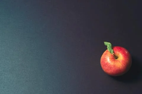 One apple on a stone kitchen table close up Stock Photos