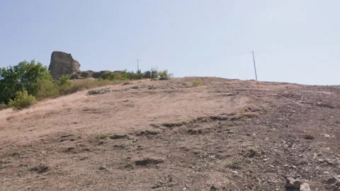 One bald guy is hiking in the mountains on a sunny bright day Stock Footage 248868403