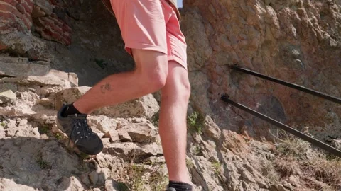 One bald guy is hiking in the mountains on a sunny bright day Video stock 248868429