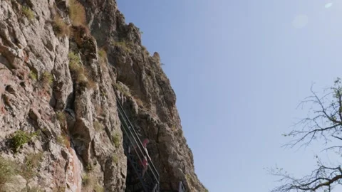 One bald guy is hiking in the mountains on a sunny bright day Video stock 248870059