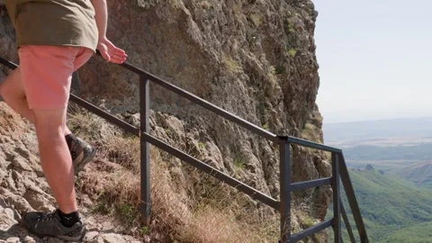 One bald guy is hiking in the mountains on a sunny bright day Video stock 248870060