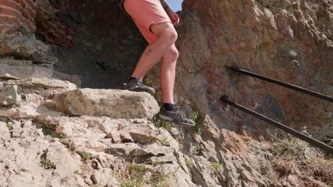 One bald guy is hiking in the mountains on a sunny bright day Stock Footage 248870432