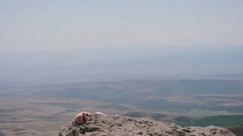 One bald guy is hiking in the mountains on a sunny bright day Stock Footage 248870810
