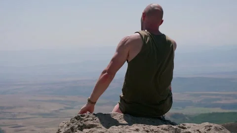 One bald guy is hiking in the mountains on a sunny bright day Stock Footage 248870878