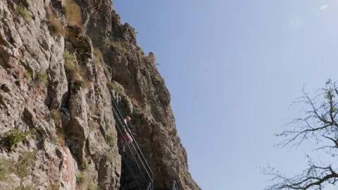 One bald guy is hiking in the mountains on a sunny bright day Stock Footage 248871045