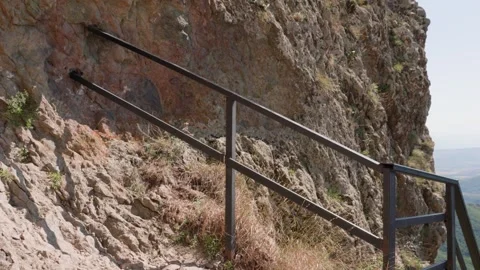 One bald guy is hiking in the mountains on a sunny bright day Stock Footage 248888534