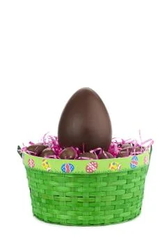 One big brown easter egg in green basket Stock Photos