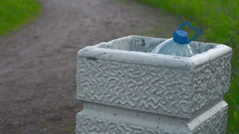 One big plastic bottle in urn in the park.Plastic pollution Video stock 155347920