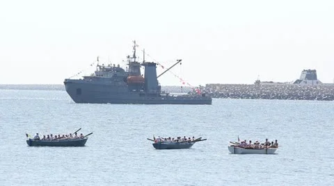 One big ship and three paddle boats sailing offshore Stock Footage 12273971