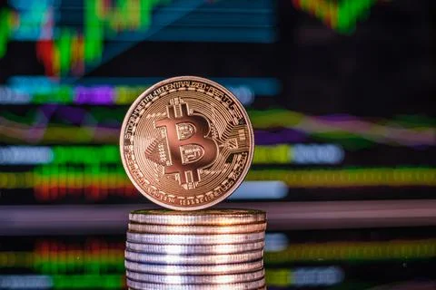 One  bitcoin coin on a stack of other coins Stock Photos